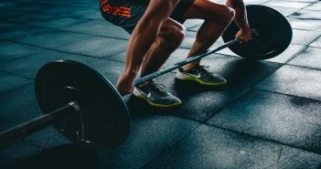 Four Full-Body Workout Exercises to Achieve That Fit Body holding barbell exercise fitness gym workout